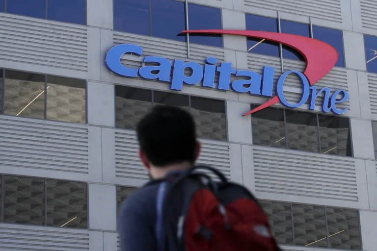 A man walking past Capital One building